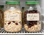 Jars of oats and raisins labeled 'Coconut Loaf' and 'Mushroom Loaf' on a refrigerator shelf with text 'Keep Your Salads Fresh and Crisp'.